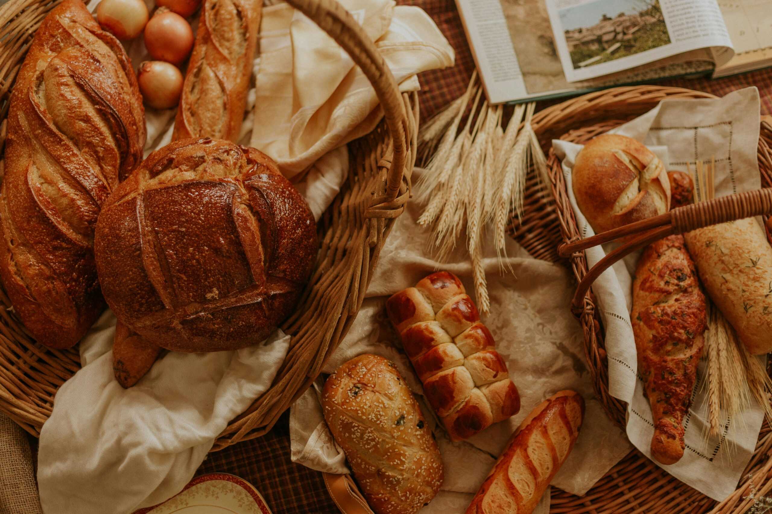 pexels photo 6966616 6966616 scaled An assortment of artisanal bread displayed in wicker baskets, creating a rustic and warm atmosphere.